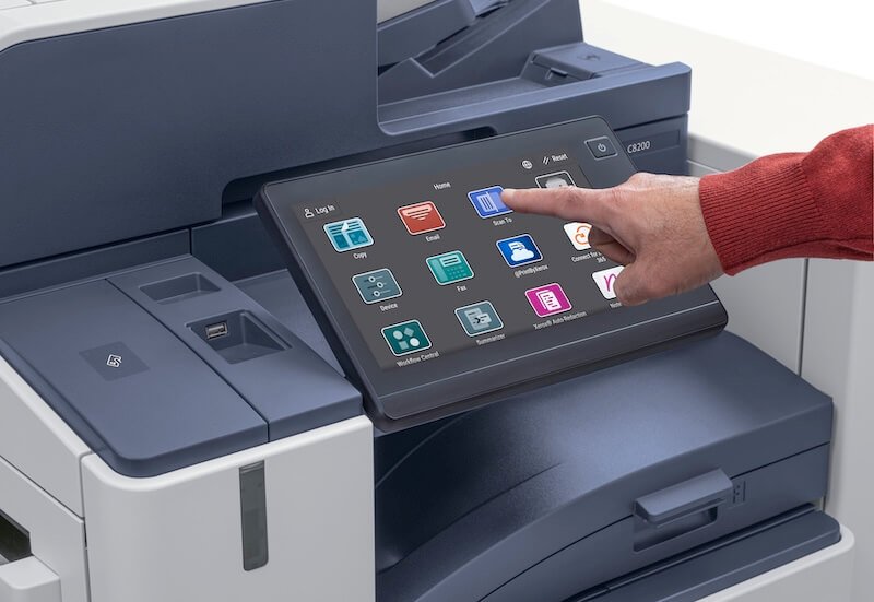 Person using Xerox printer touchscreen interface