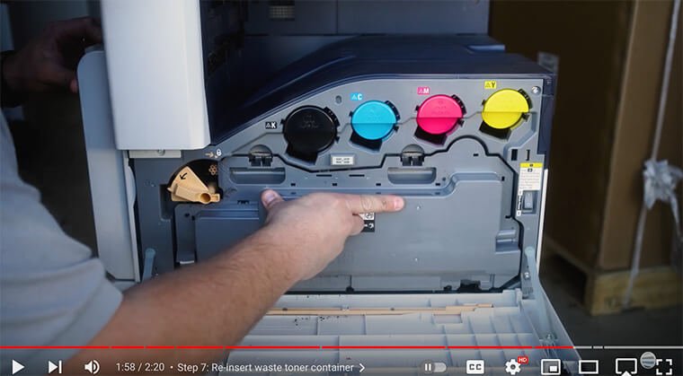 Printer technician re-inserts waste toner container on Xerox VersaLink C7000 Series printer