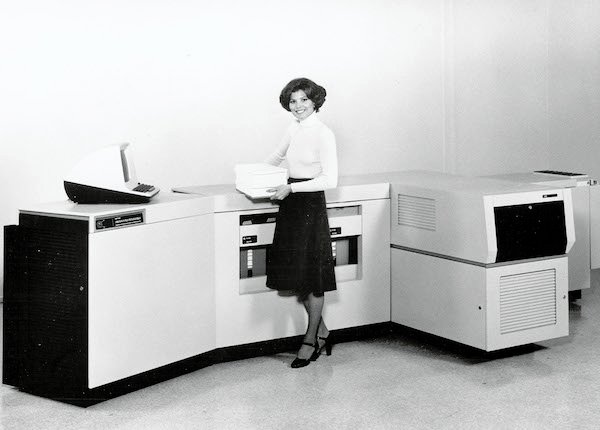 Woman standing near the Xerox 9700 printer