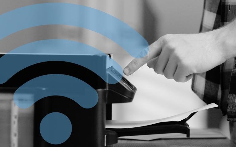 Man&#039;s hand pressing a button on a home printer