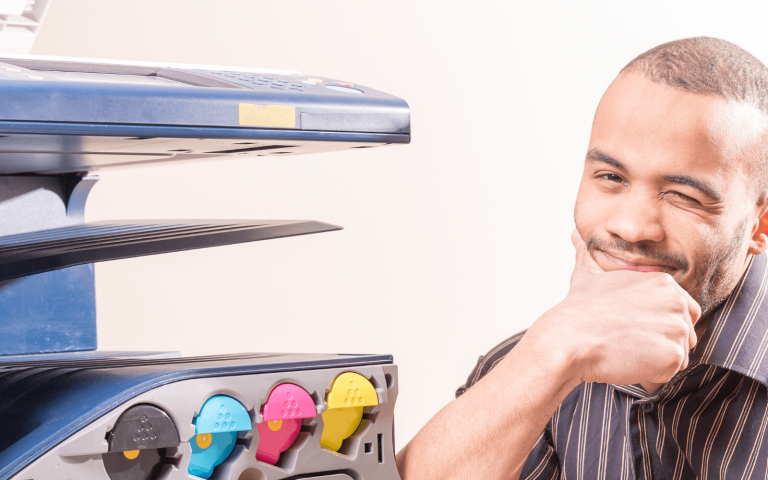 man standing by printer