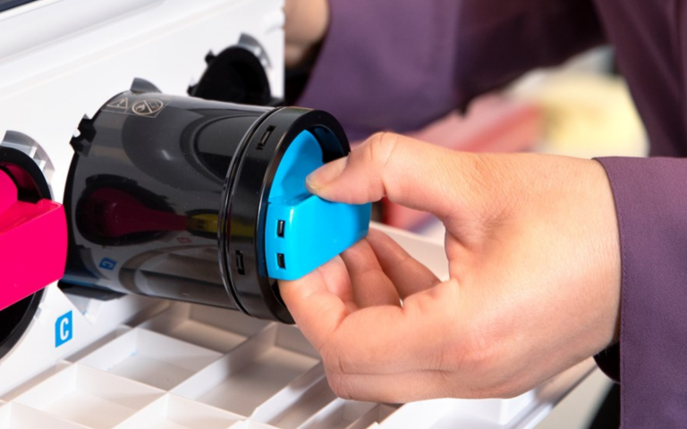 Blue toner cartridge being inserted into the printer