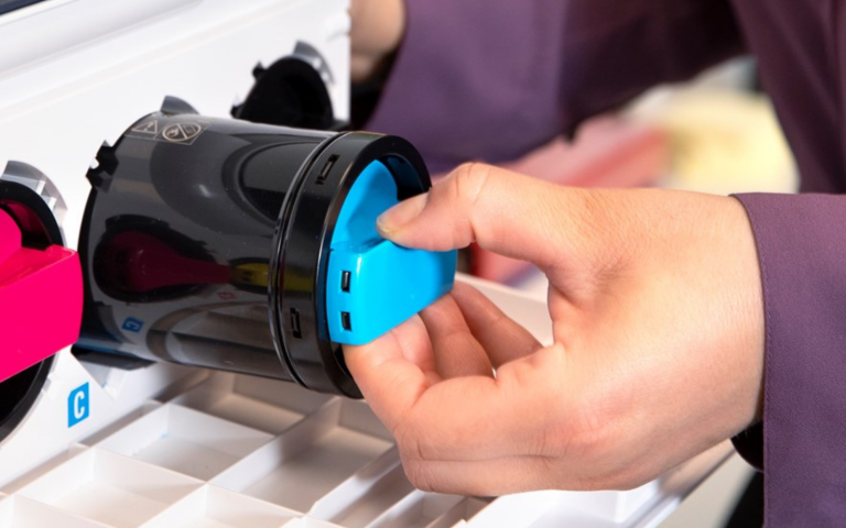 Blue toner cartridge being inserted into the printer 