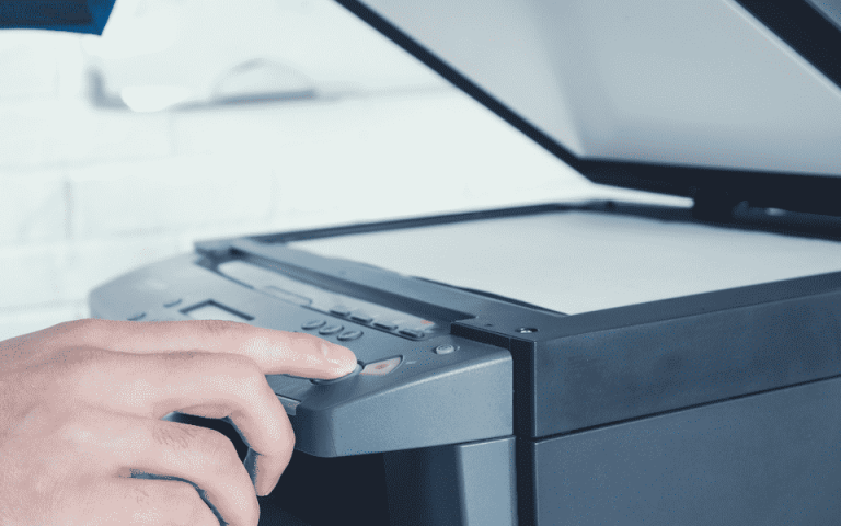 Person opening up a printer while pressing a button