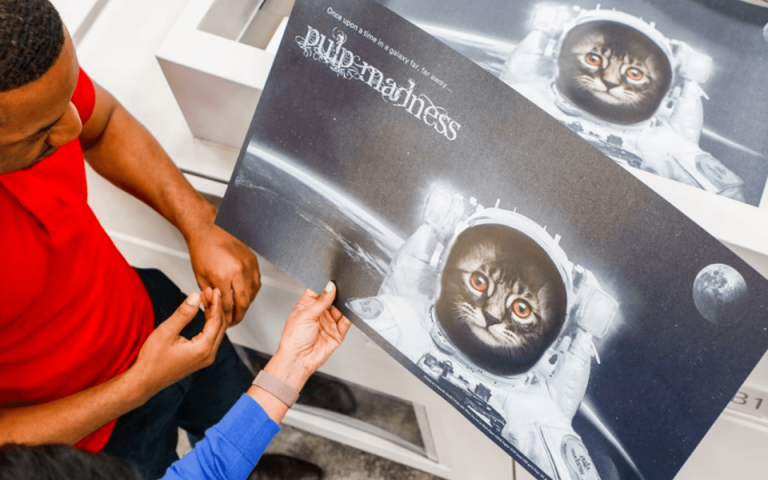Man and women looking at a print job at copier