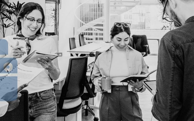 Office workers standing around with printed documents