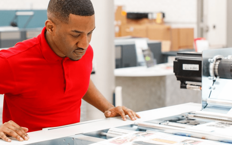 Man working with large printer