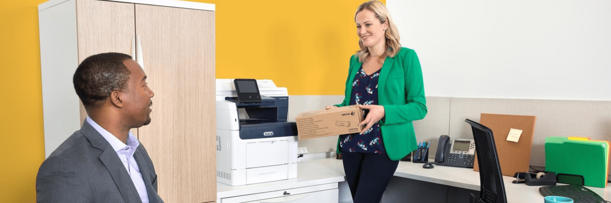 Women and man next to Xerox machine