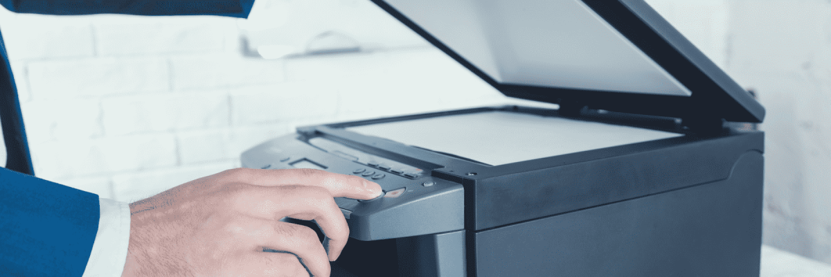 Person opening up a printer while pressing a button