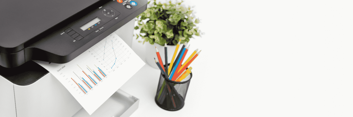 A printer next to a plant and a pencil holder