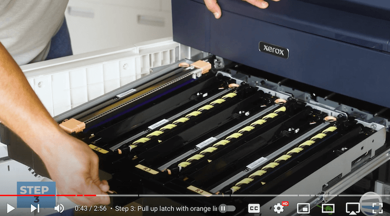 Printer technician pulls the drum tray drawer on the Xerox PrimeLink C9065