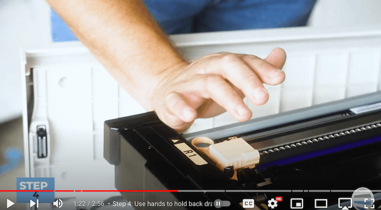 Printer technician uses the palm of his hand to hold the drum drawer in place on the Xerox PrimeLink C9065