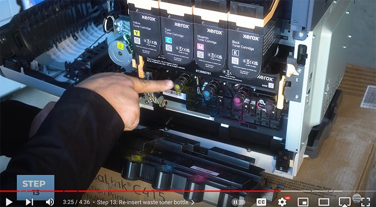 Printer technician points out springs to re-insert waste toner bottle on the Xerox VersaLink C410/C415