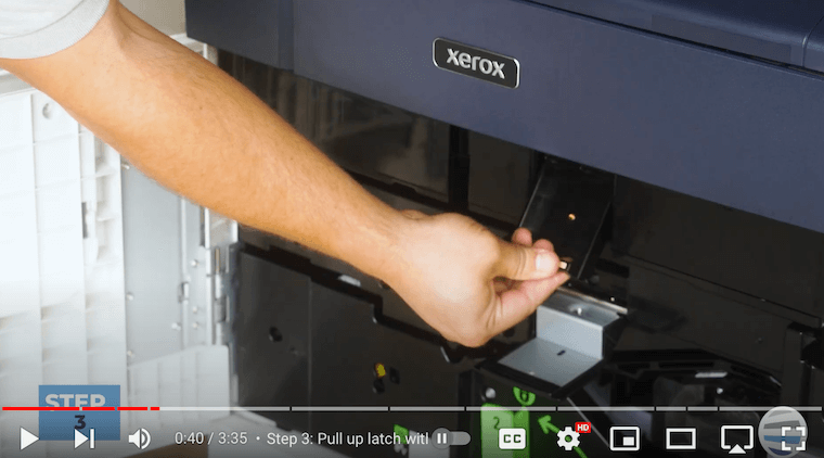Printer technician pulls up second latch with thin orange line on the Xerox PrimeLink C9065