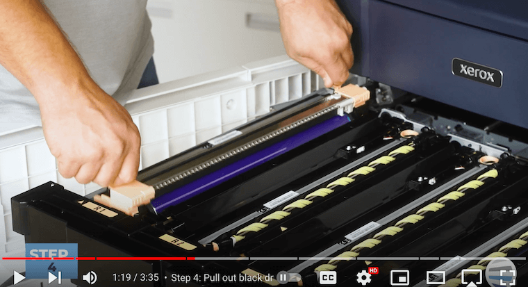 Printer technician pulls out the black drum on the Xerox PrimeLink C9065