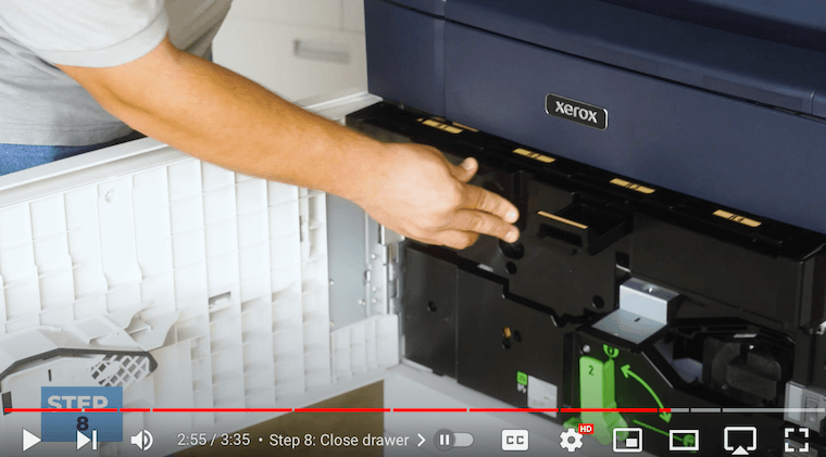 Printer technician closes the drum drawer on the Xerox PrimeLink C9065