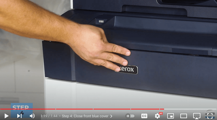 Printer technician closes front cover on the Xerox PrimeLink C9065/C9070/C60/C70