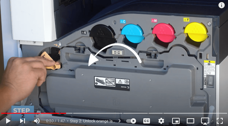 Printer technician unlocks the orange latch on the Xerox VersaLink C7030