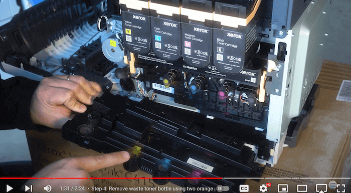 Printer technician inserts new waste toner bottle on Xerox C410/C415