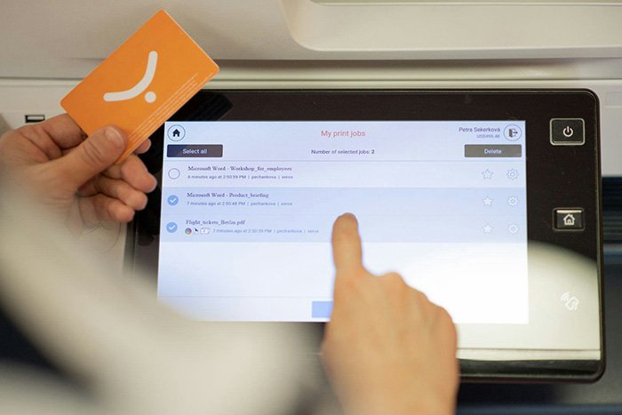 An example of someone using a Y Soft badge to release a print job.